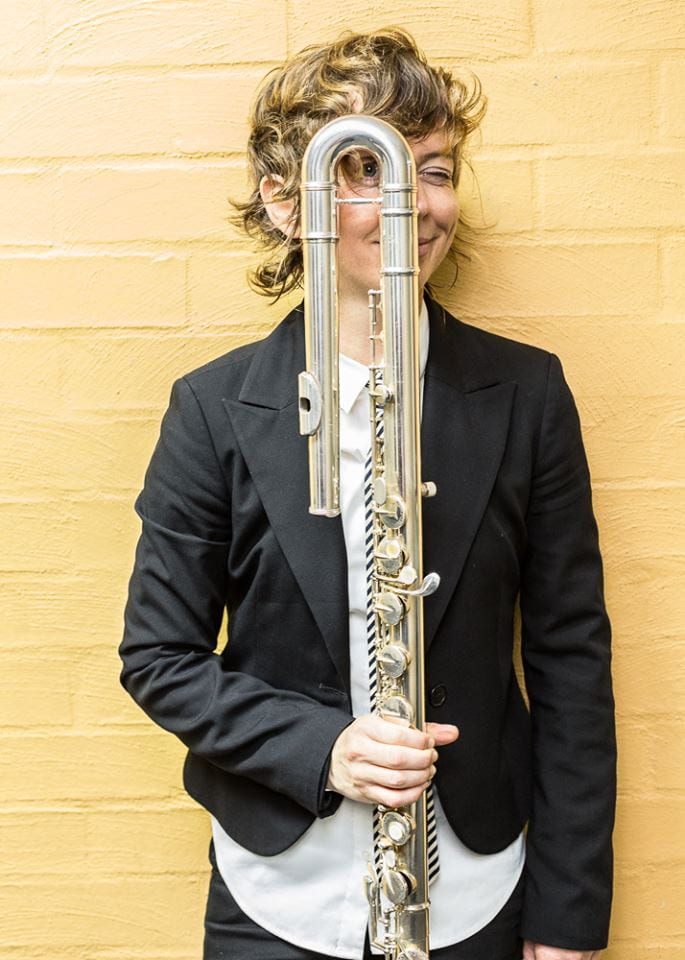 Harvard Music Professor of the Practice Claire Chase poses with one of her flutes